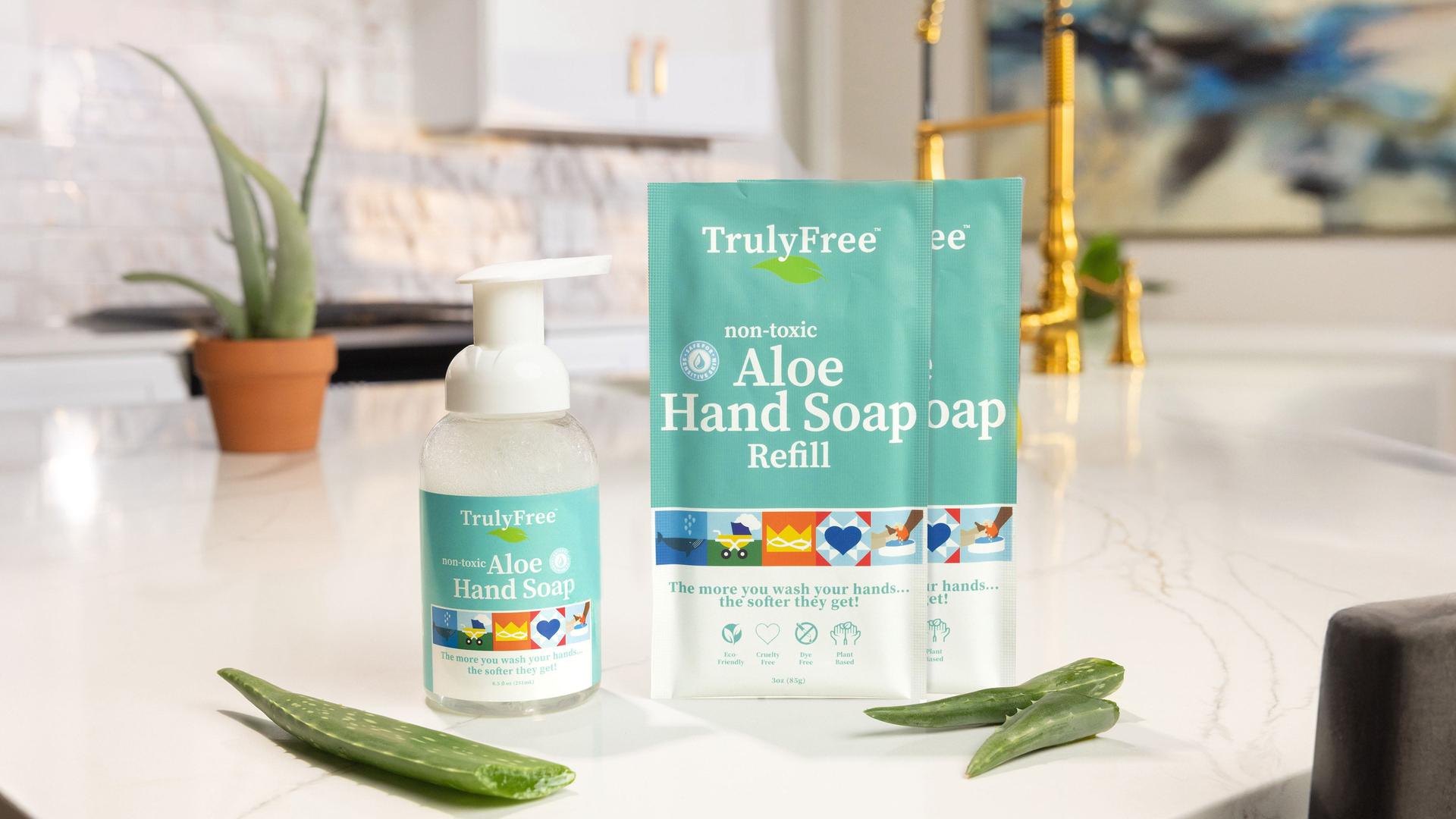 TrulyFree Aloe Hand Soap and refill pouches with aloe vera leaves